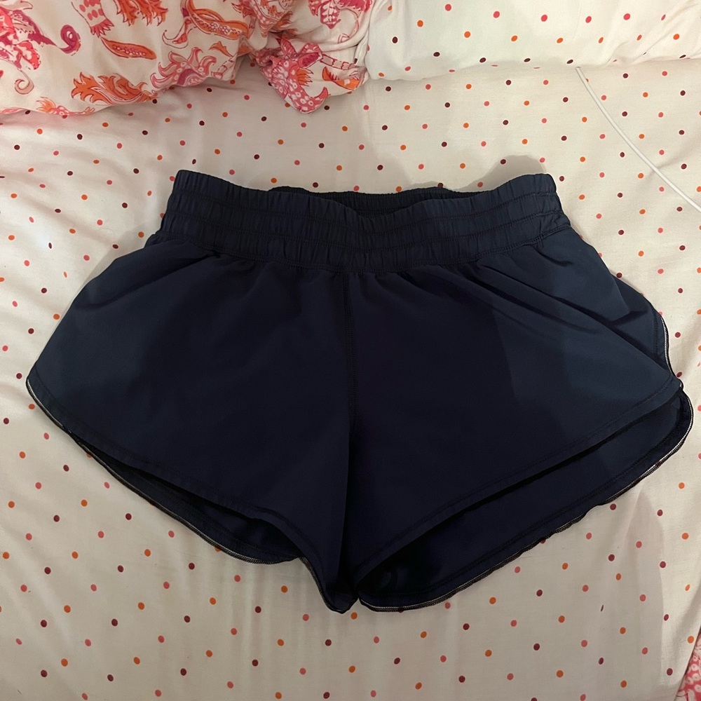Forest green lululemon shorts with black mesh trim